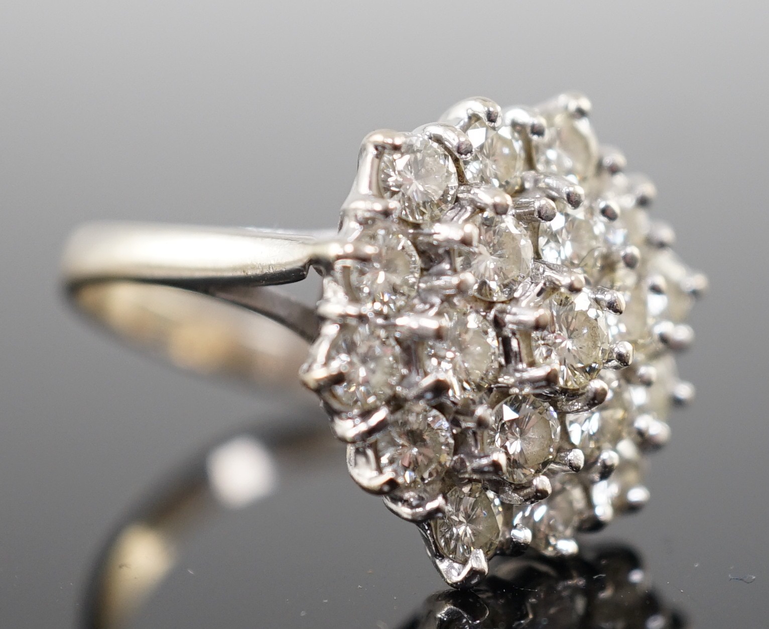 An 18ct white gold and diamond set hexagonal cluster ring